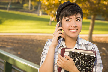 Image showing Mixed Race Female Student Holding Books and Talking on Phone