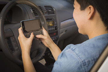 Image showing Mixed Race Woman Texting and Driving