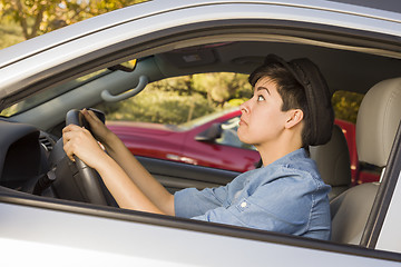 Image showing Stressed Mixed Race Woman Driving in Car and Traffic