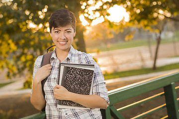 Image showing Portrait of a Pretty Mixed Race Female Student Holding Books