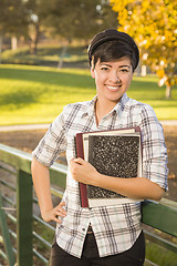 Image showing Portrait of a Pretty Mixed Race Female Student Holding Books