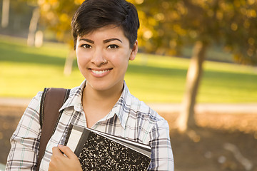 Image showing Portrait of a Pretty Mixed Race Female Student Holding Books