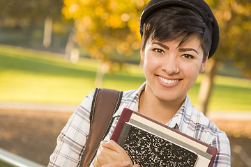 Image showing Portrait of a Pretty Mixed Race Female Student Holding Books