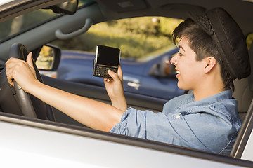 Image showing Mixed Race Woman Texting and Driving