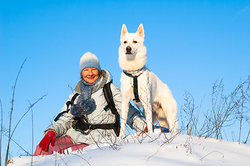 Image showing The woman with a dog in winter on walk