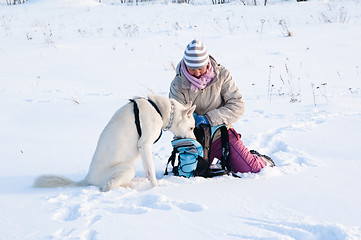 Image showing The woman with a dog in winter on walk