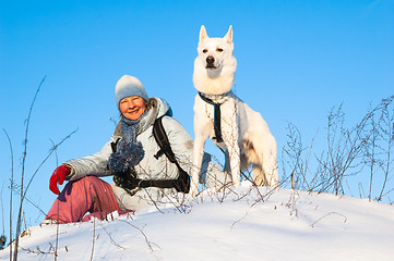 Image showing The woman with a dog in winter on walk