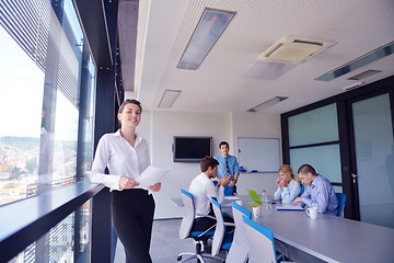 Image showing business woman with her staff in background at office