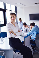 Image showing business woman with her staff in background at office