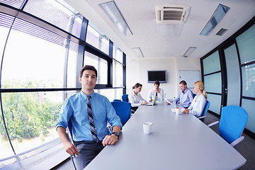 Image showing business man  on a meeting in offce with colleagues in backgroun