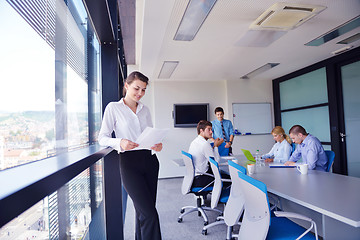 Image showing business woman with her staff in background at office