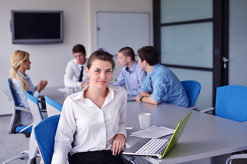 Image showing business woman with her staff in background at office