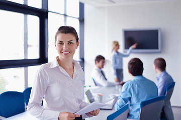 Image showing business woman with her staff in background at office