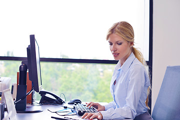 Image showing business woman working on her desk in an office