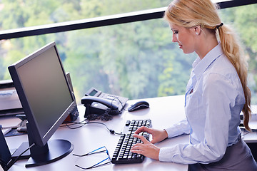 Image showing business woman working on her desk in an office