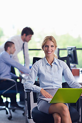 Image showing business woman with her staff in background at office