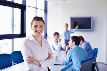 Image showing business woman with her staff in background at office