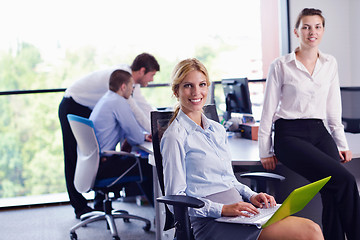 Image showing business woman with her staff in background at office