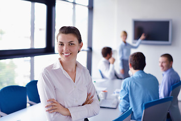 Image showing business woman with her staff in background at office