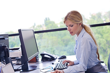 Image showing business woman working on her desk in an office