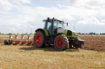 Image showing tractor plowing agricultural field autumn 