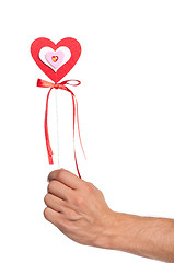 Image showing Hand with heart on a stick