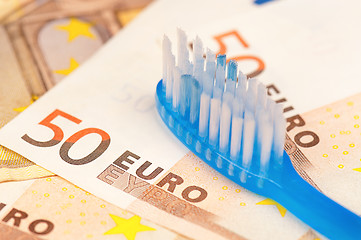 Image showing Euro and tooth brush