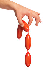 Image showing Hand with sausage