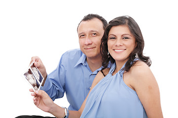 Image showing Attractive hispanic young pregnant couple expecting a child hold