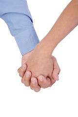 Image showing Closeup of young affectionate couple holding hands over white ba