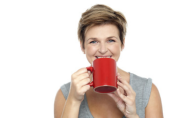 Image showing Young woman enjoying her coffee