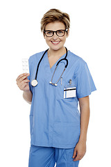 Image showing Doctor at duty holding medicine pack in hand