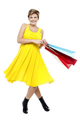 Image showing Portrait of beautiful young woman carrying shopping bags