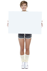 Image showing Pretty woman presenting blank whiteboard
