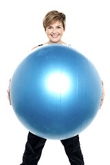 Image showing Charming woman holding big blue fitness ball