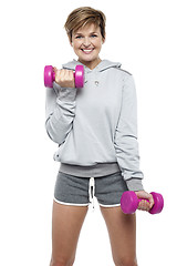 Image showing Sporty middle aged woman with dumbbells