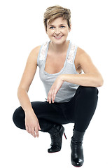 Image showing Charming woman in squatting posture