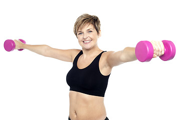 Image showing Fitness woman working out with pink dumbbells