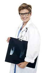 Image showing Female doctor holding x-ray report