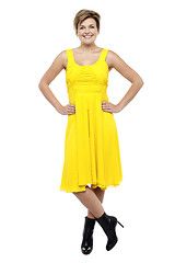 Image showing Attractive blonde wearing bright yellow frock