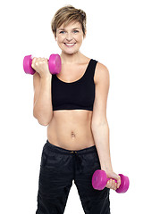 Image showing Cheerful middle-aged woman woman working out