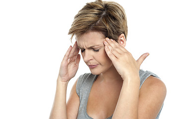 Image showing Woman having headache. Holding her head