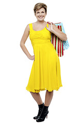 Image showing Portrait of a happy woman carrying shopping bags