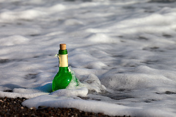 Image showing Bottle of wine in sea surf