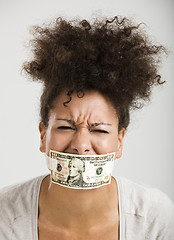 Image showing Covering mouth with a dollar banknote