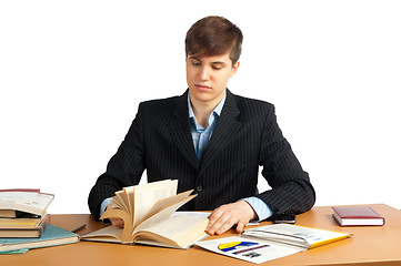 Image showing cute man reading a book at table