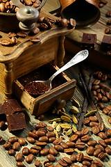 Image showing Ground coffee in an old mill, chocolate and cardamom.