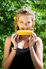 Image showing woman eating corn-cob