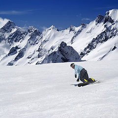 Image showing Snowboarder on ski piste in high mountains