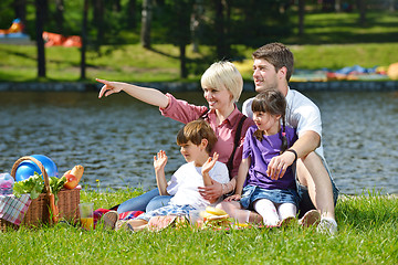 Image showing Happy family playing together in a picnic outdoors